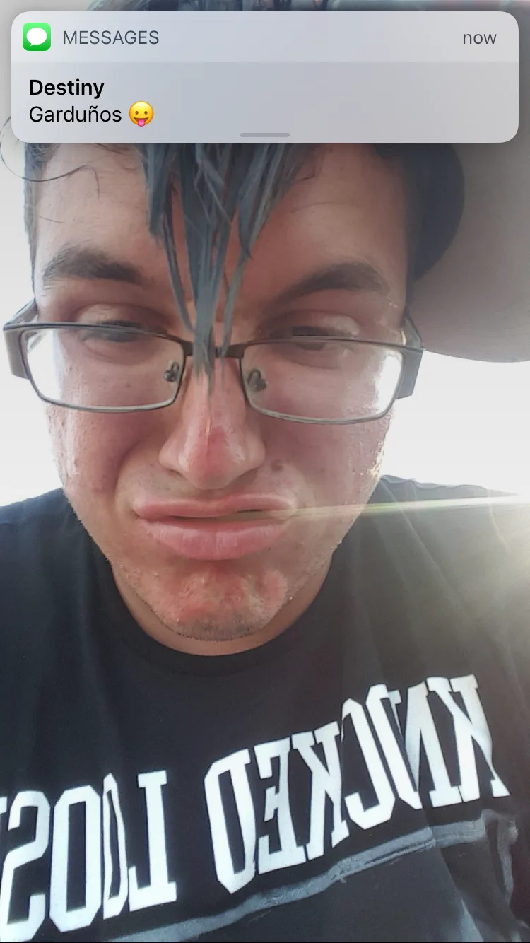 Person with blue hair and rectangular glasses